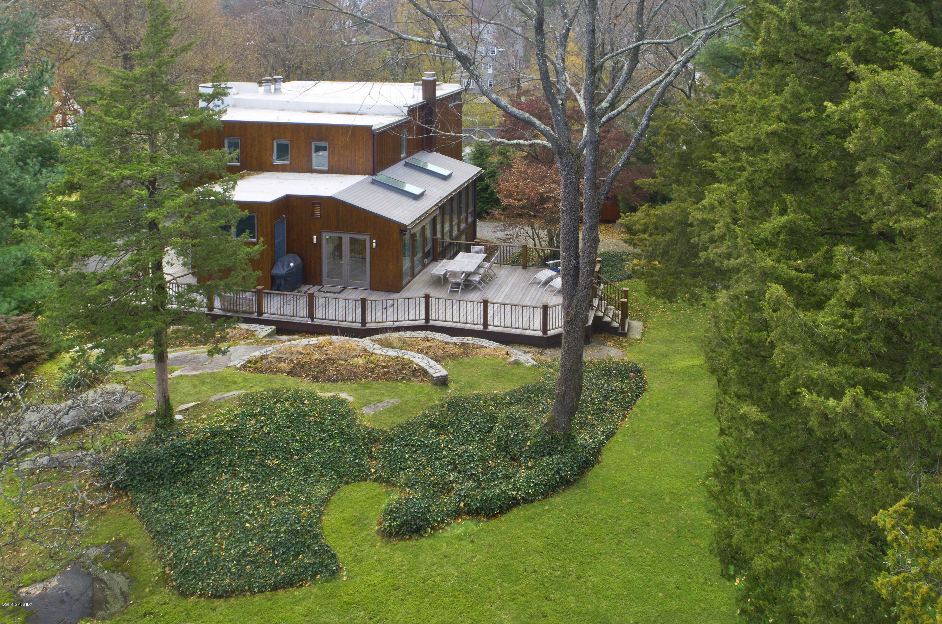 249 Shore Road Greenwich, CT 06830 - Photo 20 of 24 a view of a house with a backyard and sitting area