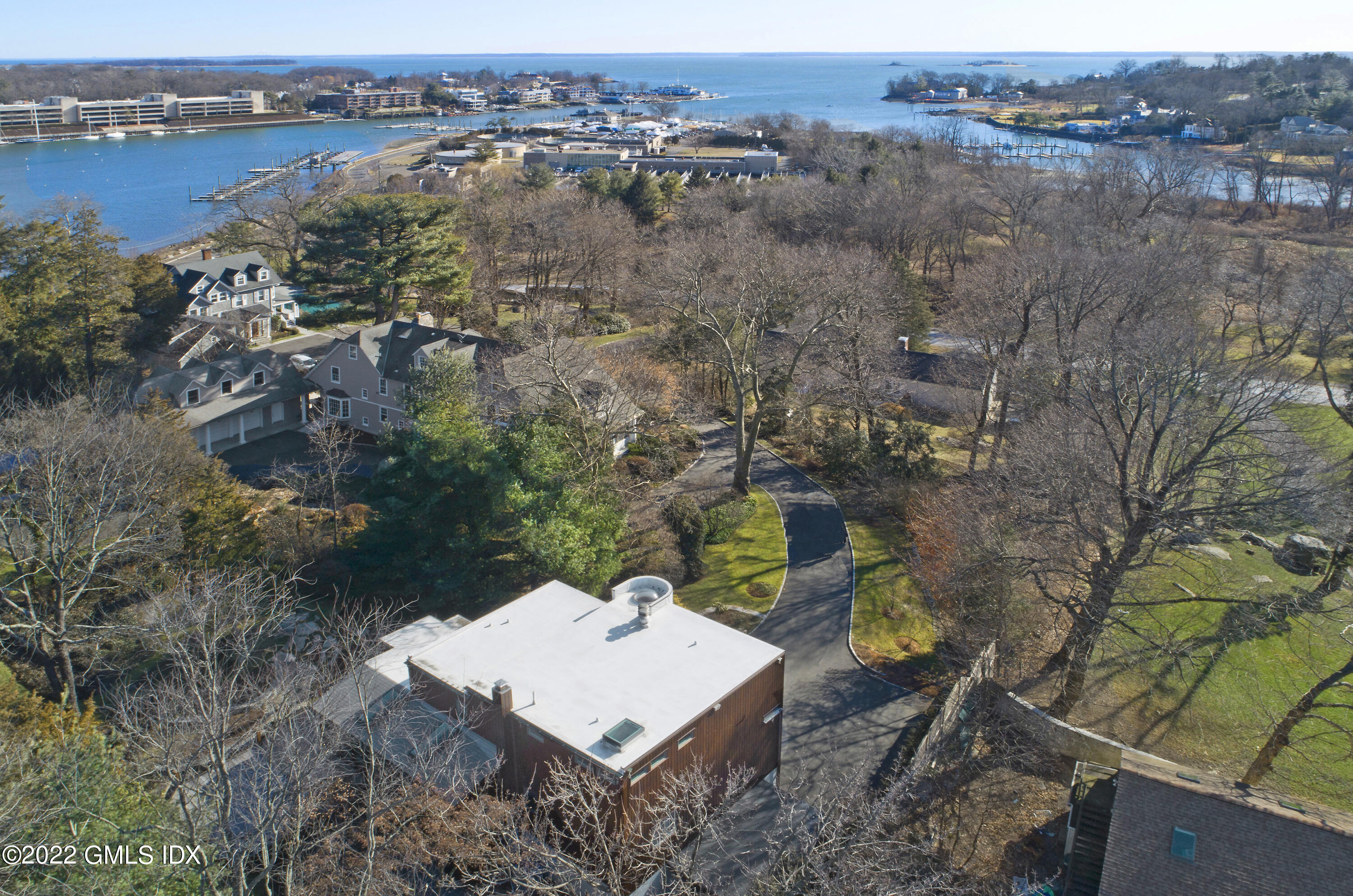 249 Shore Road Greenwich, CT 06830 - Photo 21 of 24 an aerial view of a house with a yard and lake view