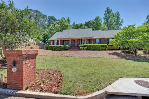a view of a house with a backyard