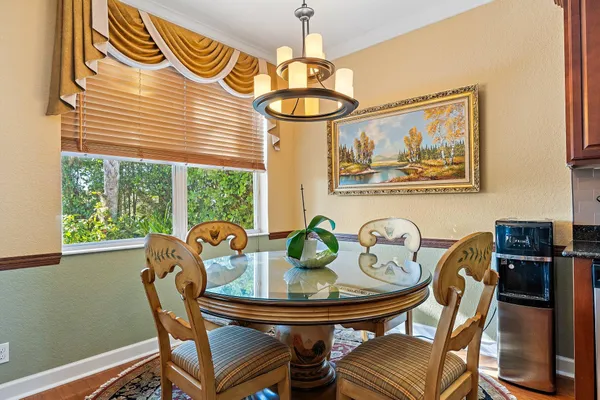 a living room with furniture a flat screen tv and a large window
