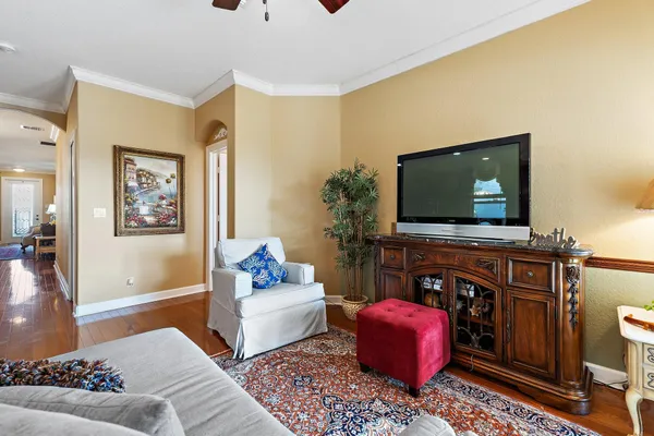 a living room with furniture kitchen view and a chandelier