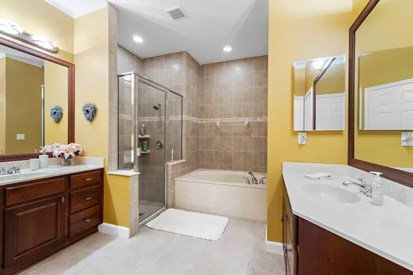 a bathroom with a tub sink toilet and a mirror