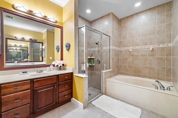 a white bath tub sitting next to a shower