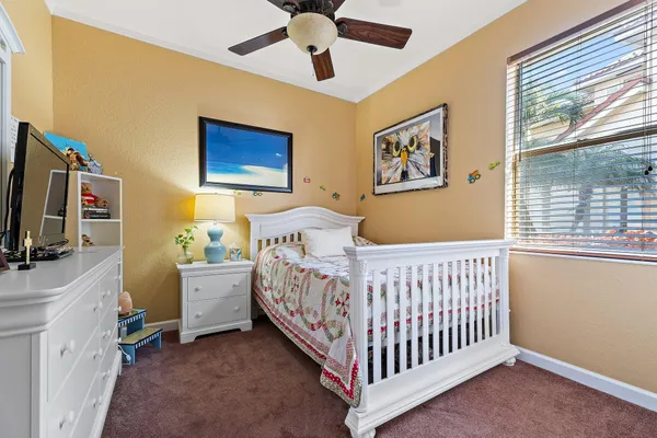 a bedroom with a bed and a painting on the wall