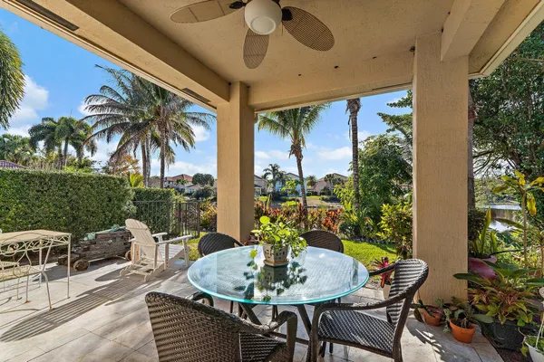 a view of an outdoor dining space with a table and chairs