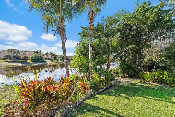a view of a house with swimming pool and sitting area