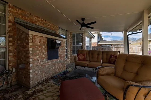 a living room with furniture and a ceiling fan