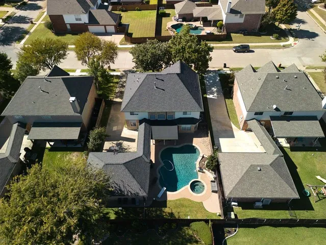 an aerial view of a house with swimming pool