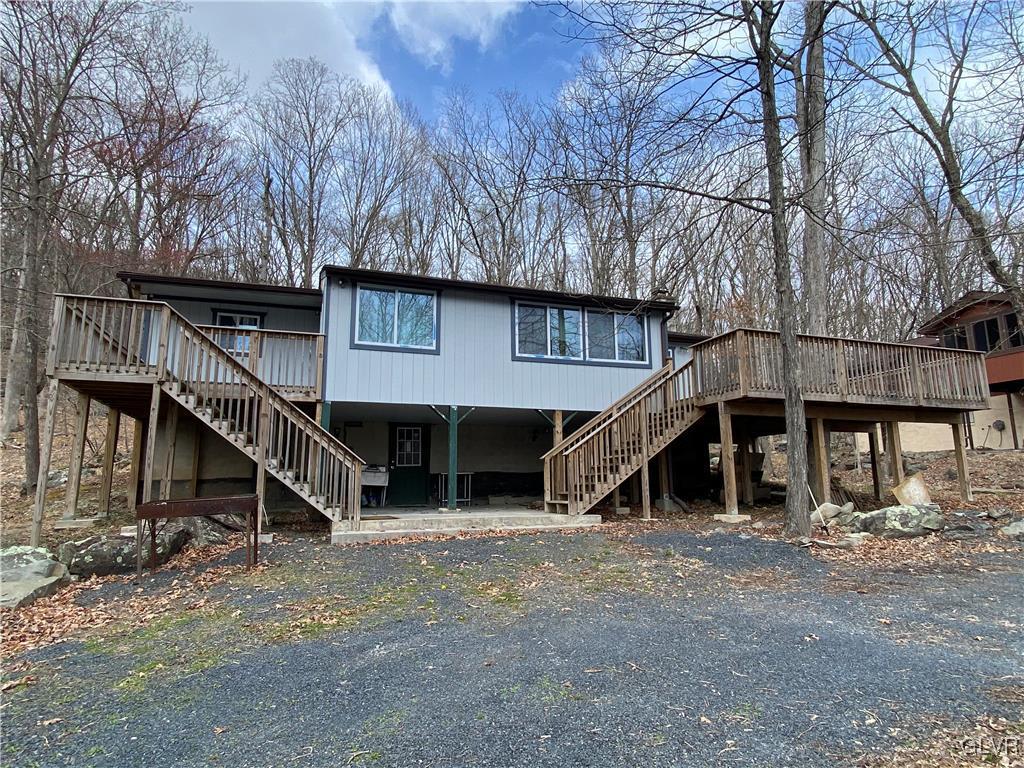 5901 Decker Road Bushkill, PA 18324 - Photo 1 of 49 a view of a house with a yard and a wooden deck
