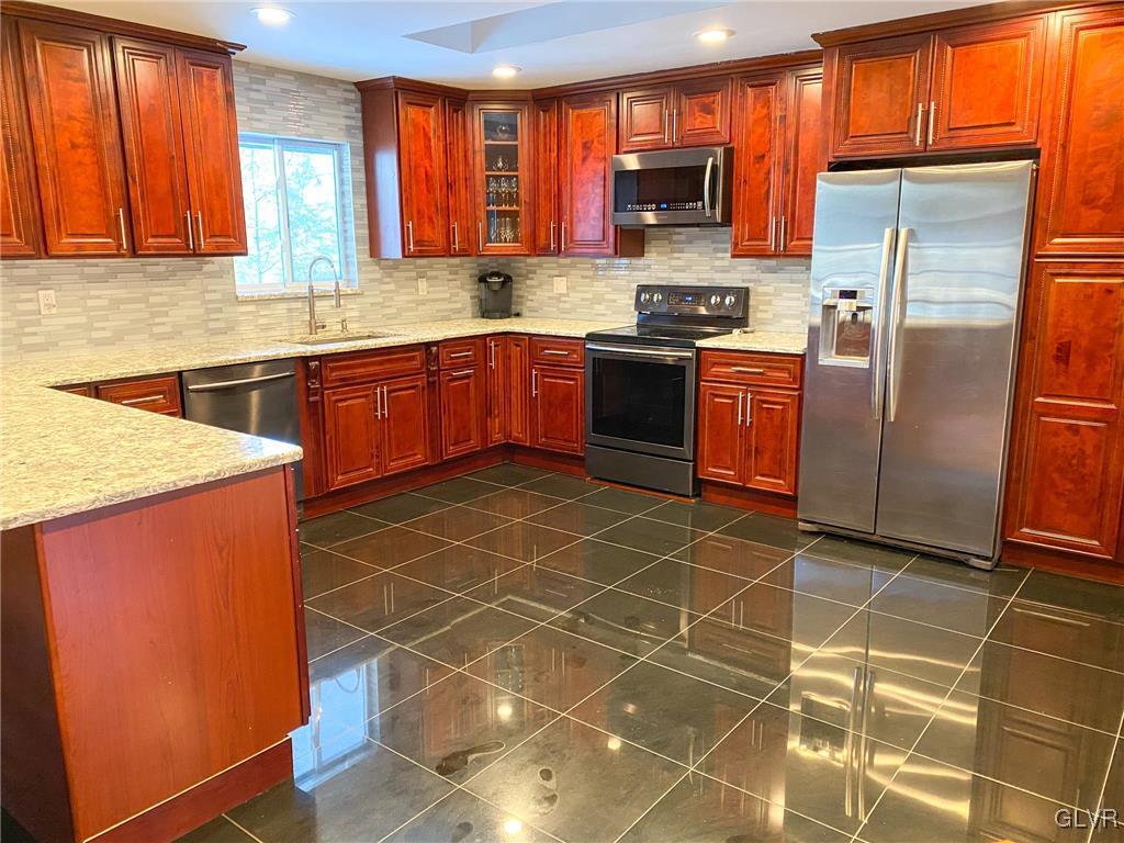 5901 Decker Road Bushkill, PA 18324 - Photo 3 of 49 a kitchen with stainless steel appliances cabinets a sink and a counter top space