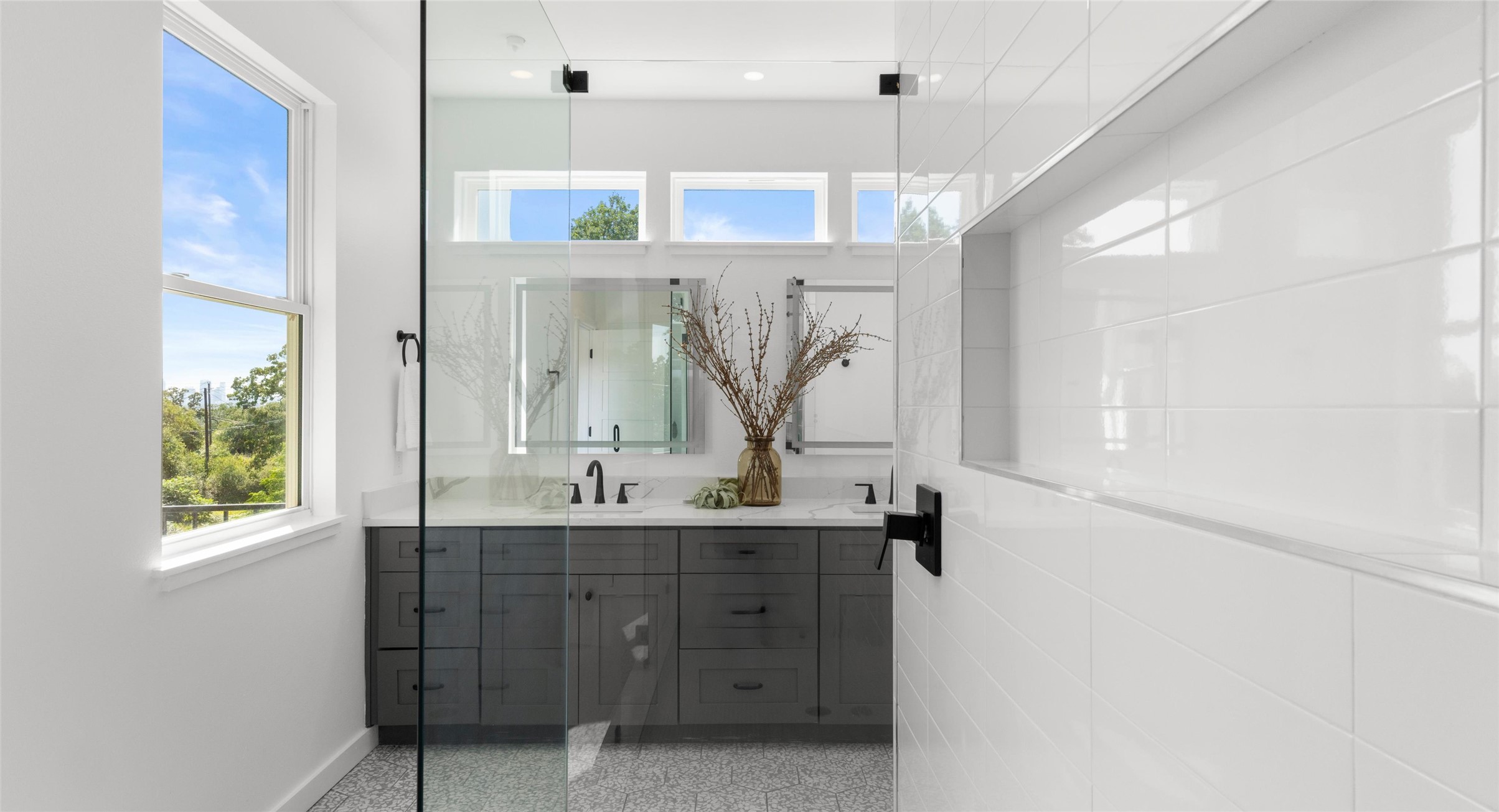 5912 Harold Court, Unit 107 Austin, TX 78721 - Photo 26 of 35 A bright primary bath with a window framing leafy views — a restful way to begin the day. Model No. 105 Shown.