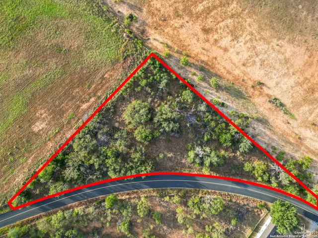 a view of a yard with a wooden fence