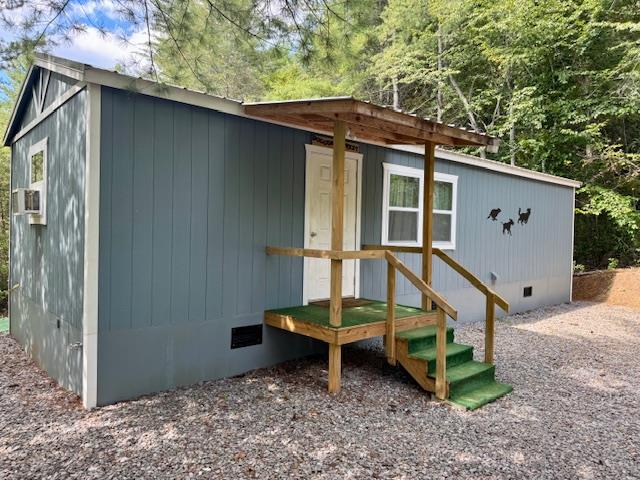 a backyard of a house with wooden fence and swing