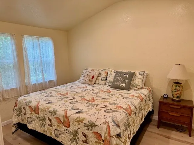 a bedroom with a bed and a lamp