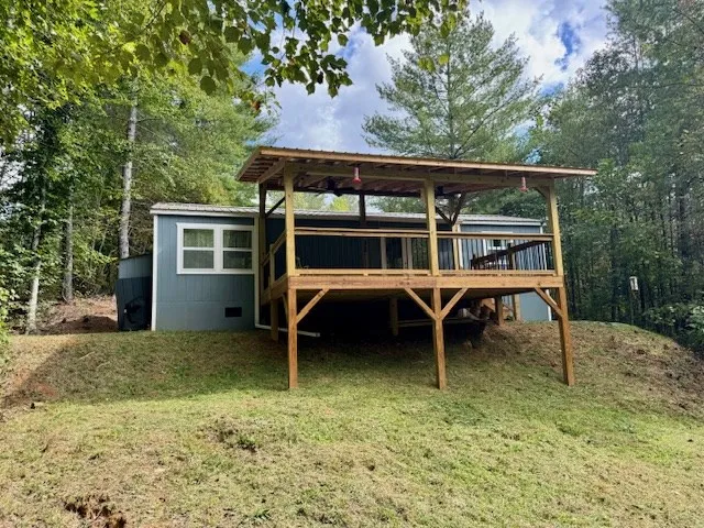 a view of a house with backyard porch and sitting area