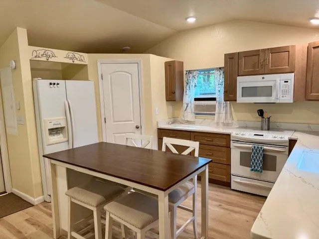 a kitchen with stainless steel appliances granite countertop a stove a refrigerator and a sink