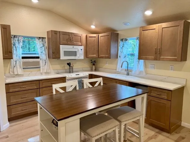 a kitchen with a stove a sink and a microwave
