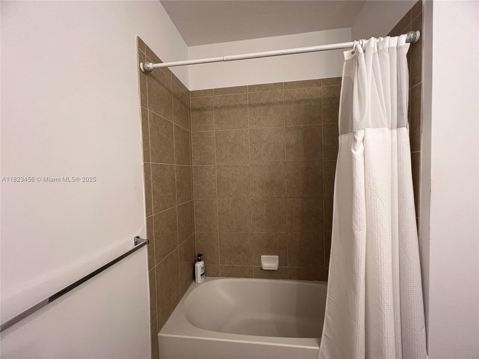 14745 Southwest 9th Street, Unit 3109 Pembroke Pines, FL 33027 - Photo 13 of 27 a bathroom with a bathtub and a shower