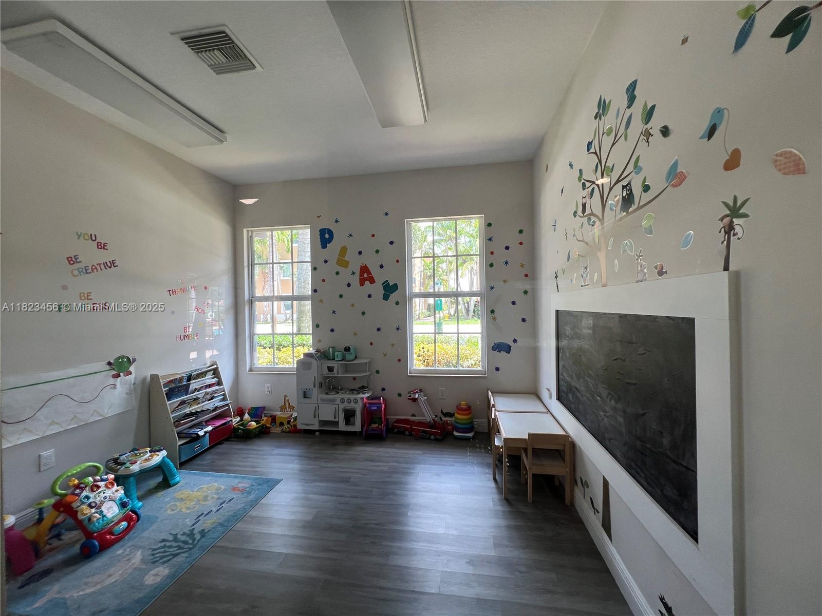 14745 Southwest 9th Street, Unit 3109 Pembroke Pines, FL 33027 - Photo 24 of 27 a living room with furniture and a flat screen tv