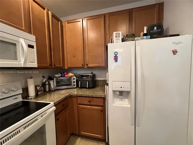 a white refrigerator freezer sitting inside of a kitchen