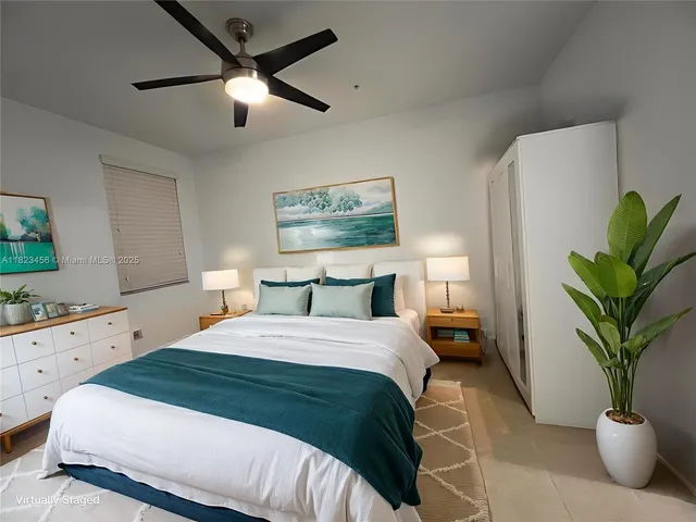 a bedroom with a bed and a potted plant