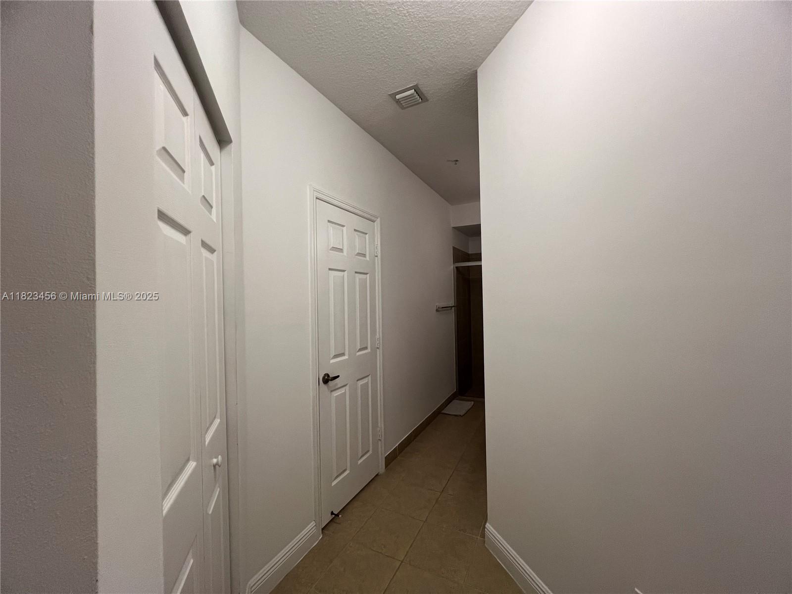 14745 Southwest 9th Street, Unit 3109 Pembroke Pines, FL 33027 - Photo 9 of 27 a view of a hallway with wooden floor and entryway