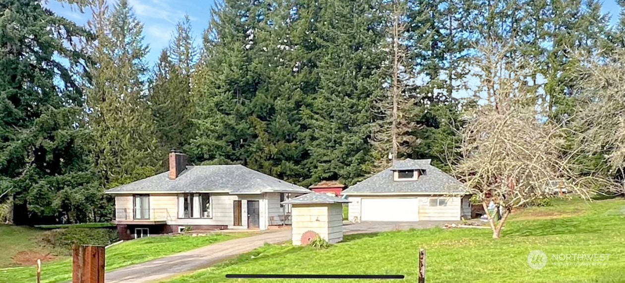 502 Kroll Road Castle Rock, WA 98611 - Photo 1 of 30 a front view of a house with garden