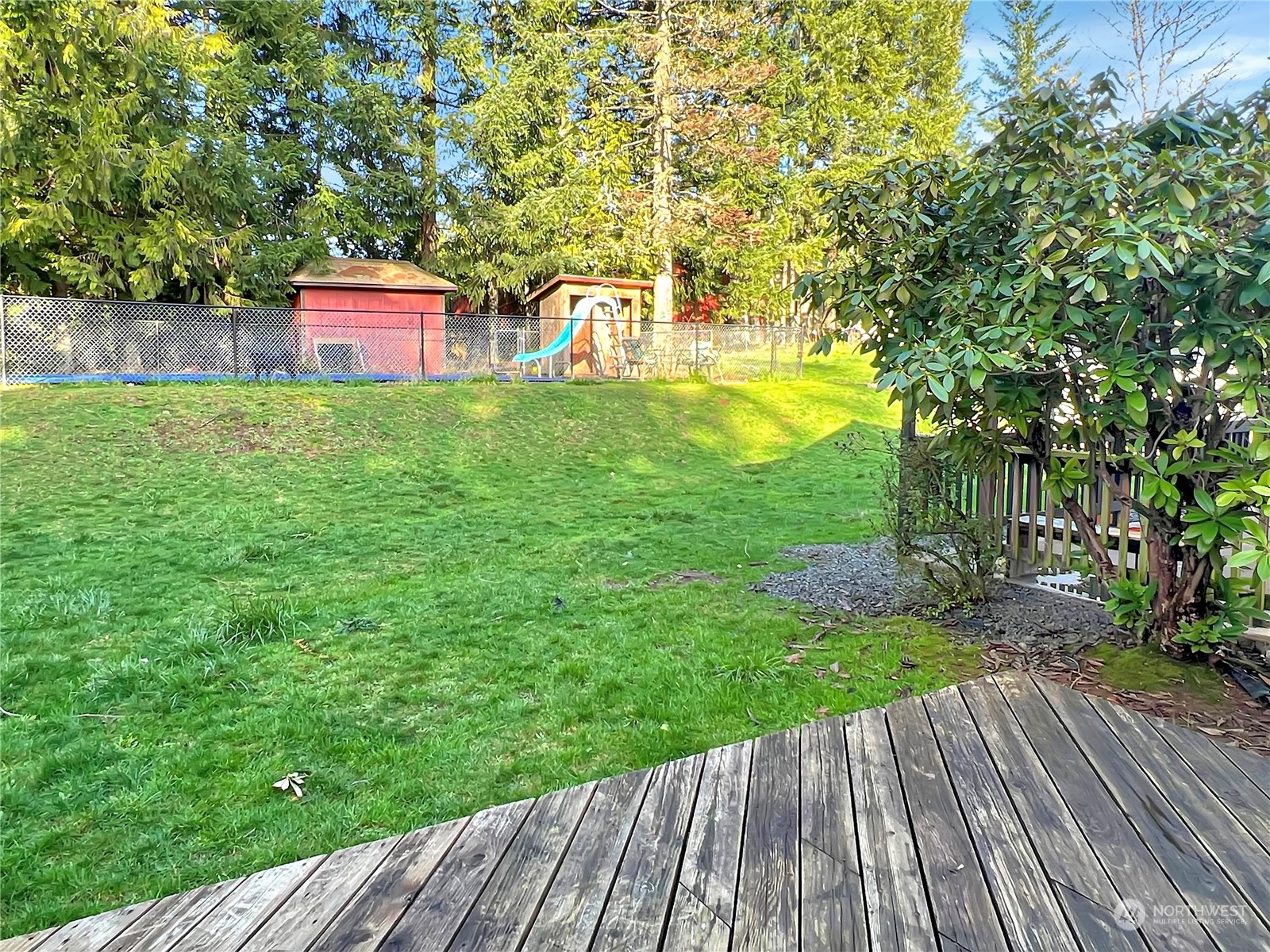 502 Kroll Road Castle Rock, WA 98611 - Photo 5 of 30 a view of a wooden deck with a yard
