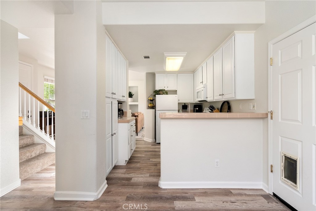 2838 Cottage Lane Paso Robles, CA 93446 - Photo 11 of 29 a kitchen with stainless steel appliances a refrigerator a stove top oven and white cabinets