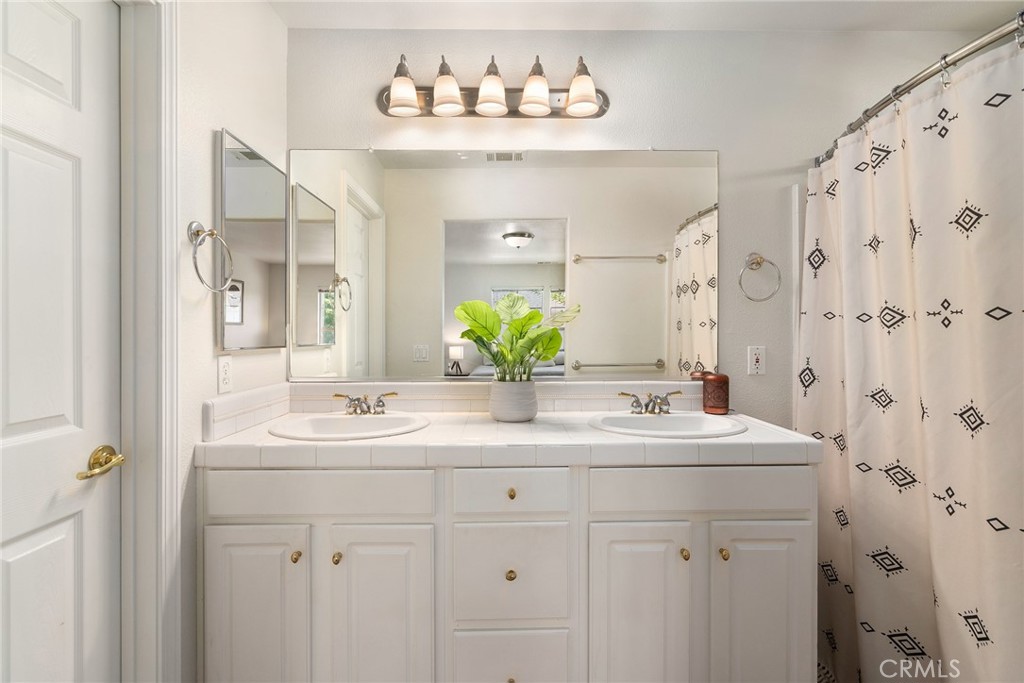 2838 Cottage Lane Paso Robles, CA 93446 - Photo 15 of 29 a bathroom with a double vanity sink mirror and double