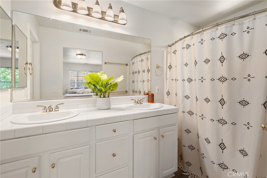 2838 Cottage Lane Paso Robles, CA 93446 - Photo 16 of 29 a bathroom with a double vanity sink mirror and shower