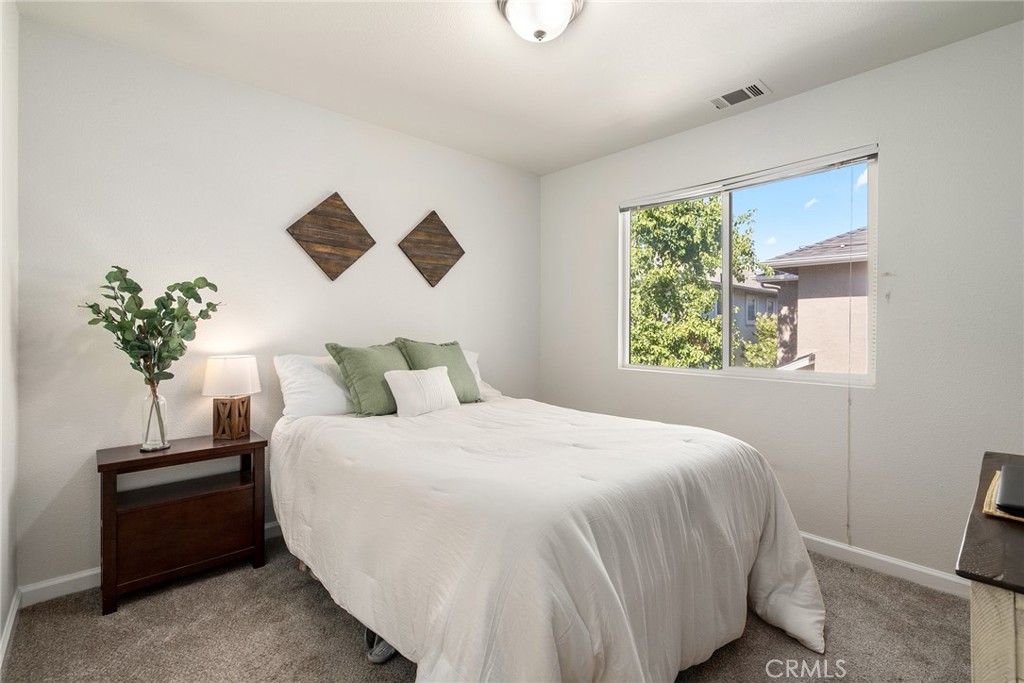 2838 Cottage Lane Paso Robles, CA 93446 - Photo 18 of 29 a bedroom with a bed and a potted plant