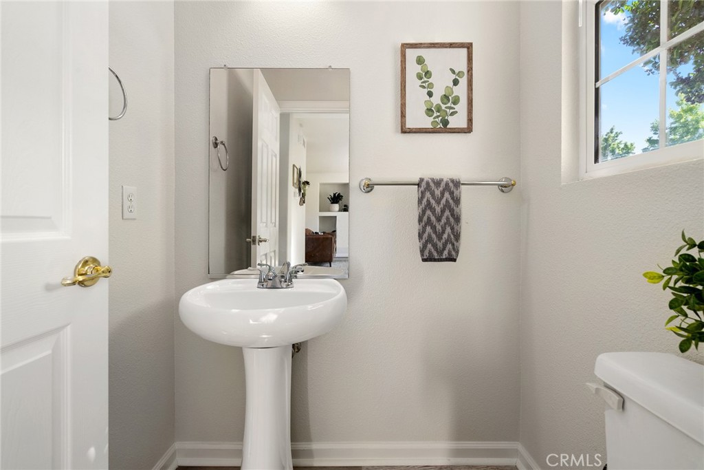 2838 Cottage Lane Paso Robles, CA 93446 - Photo 20 of 29 a bathroom with a sink a mirror and a toilet