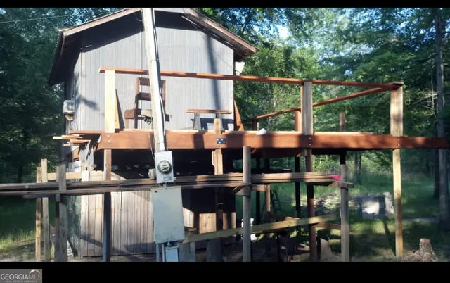 a view of a yard with large trees