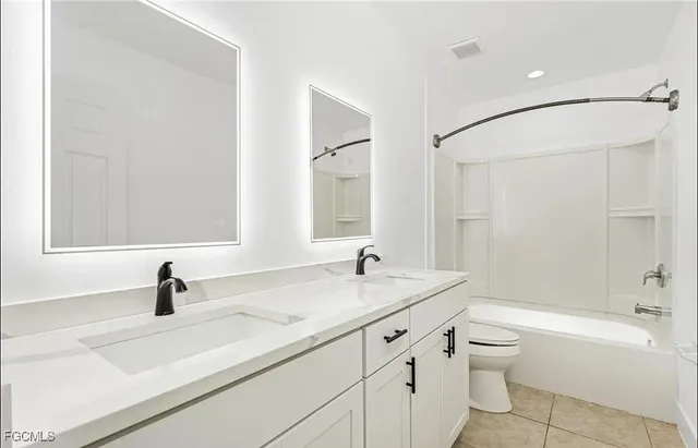 a bathroom with a sink a toilet and a bathtub