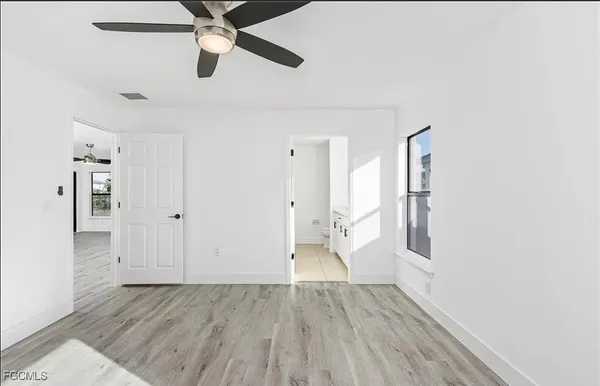 a view of empty room with wooden floor