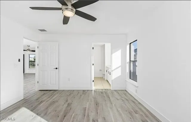 a view of empty room with wooden floor
