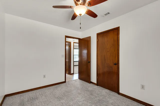 a view of a chandelier fan and closet in a room