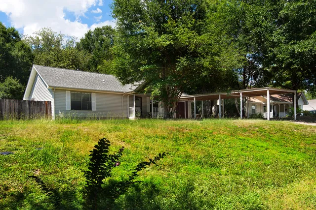 a front view of house with yard and green space