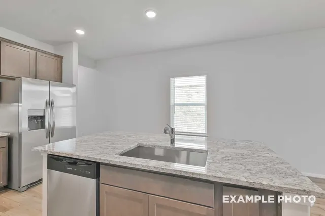a kitchen with a sink and refrigerator