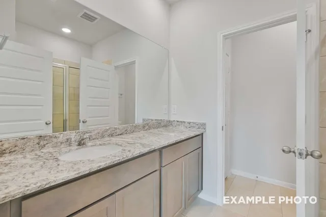a bathroom with a glass shower door