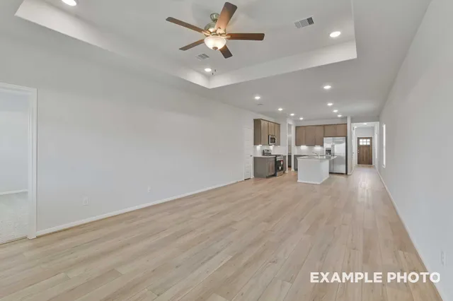 a view of a kitchen with a dishwasher and wooden floor