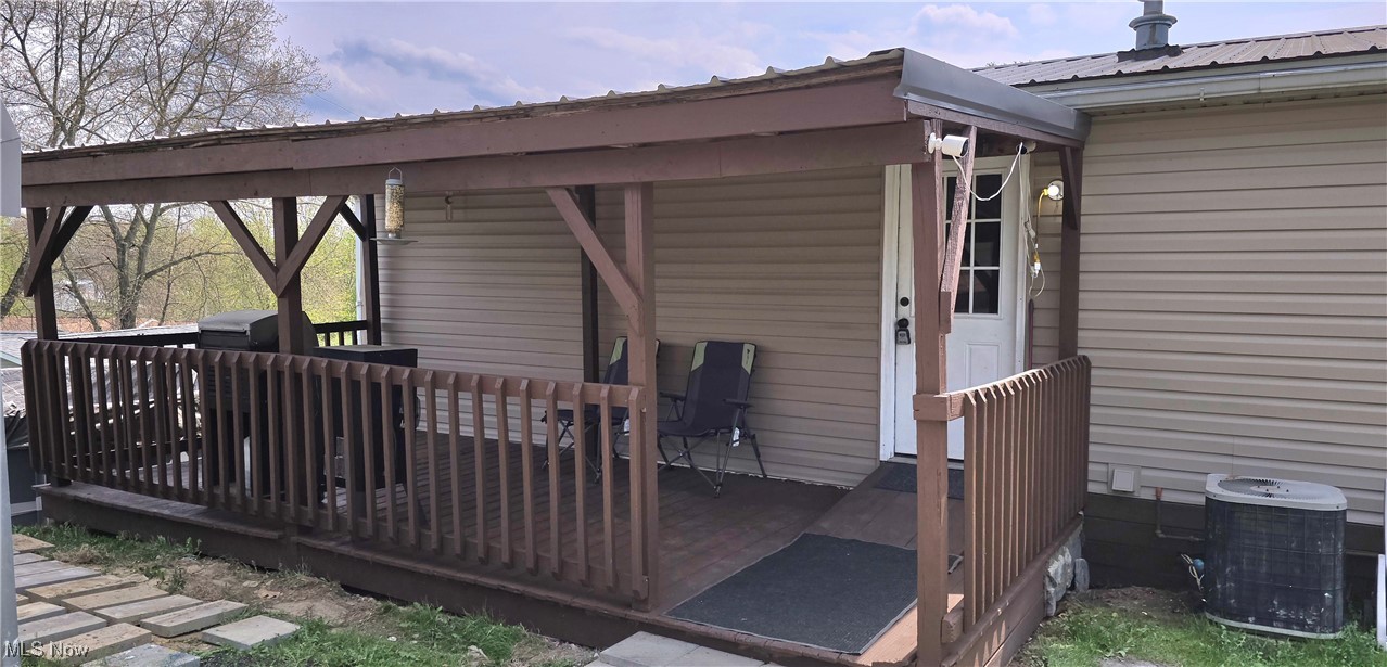 570 Timber Run Road Zanesville, OH 43701 - Photo 3 of 34 Wooden deck featuring central air condition unit