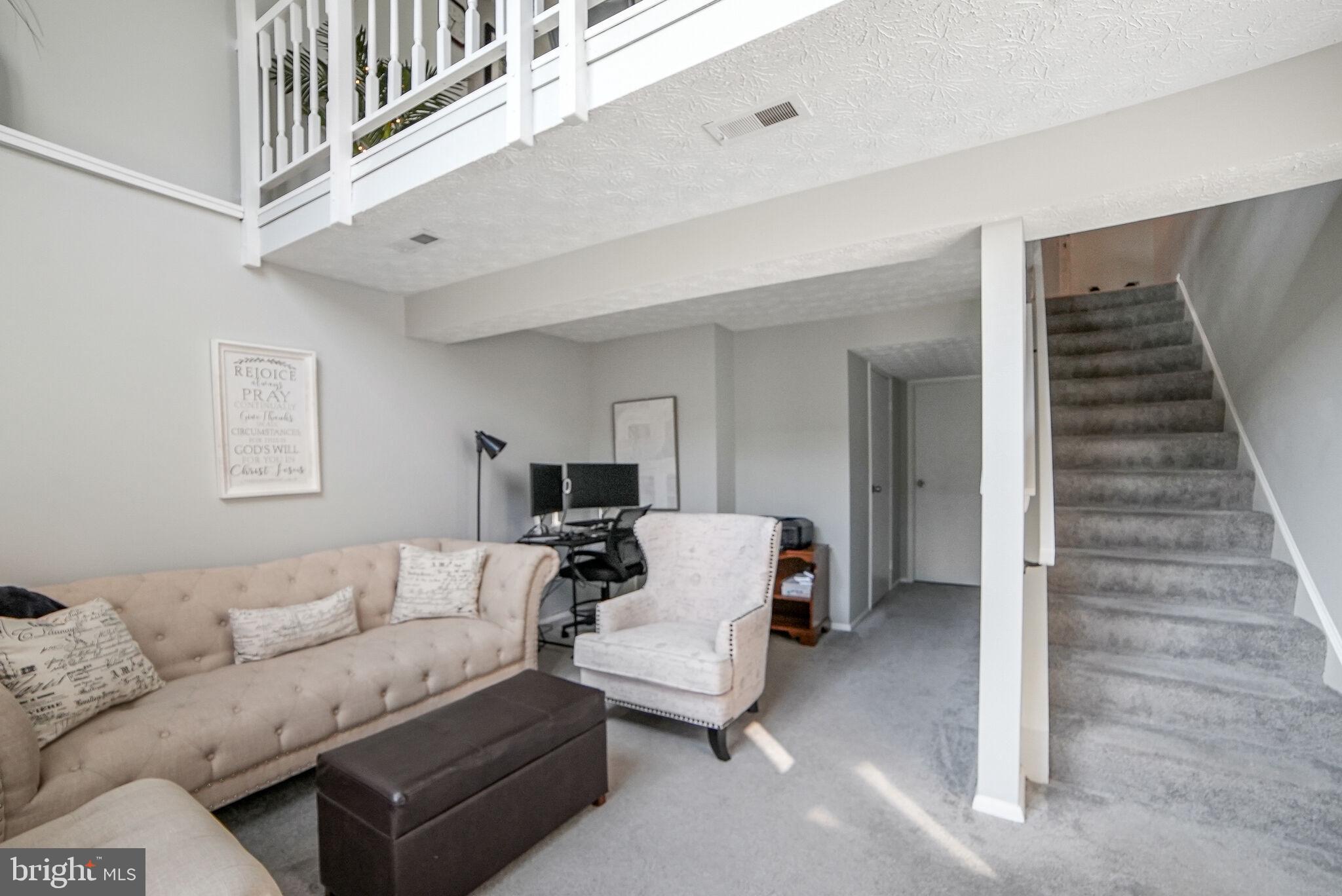 3650 Castle Terrace, Unit 11112 Silver Spring, MD 20904 - Photo 2 of 26 a living room with furniture and a ceiling fan