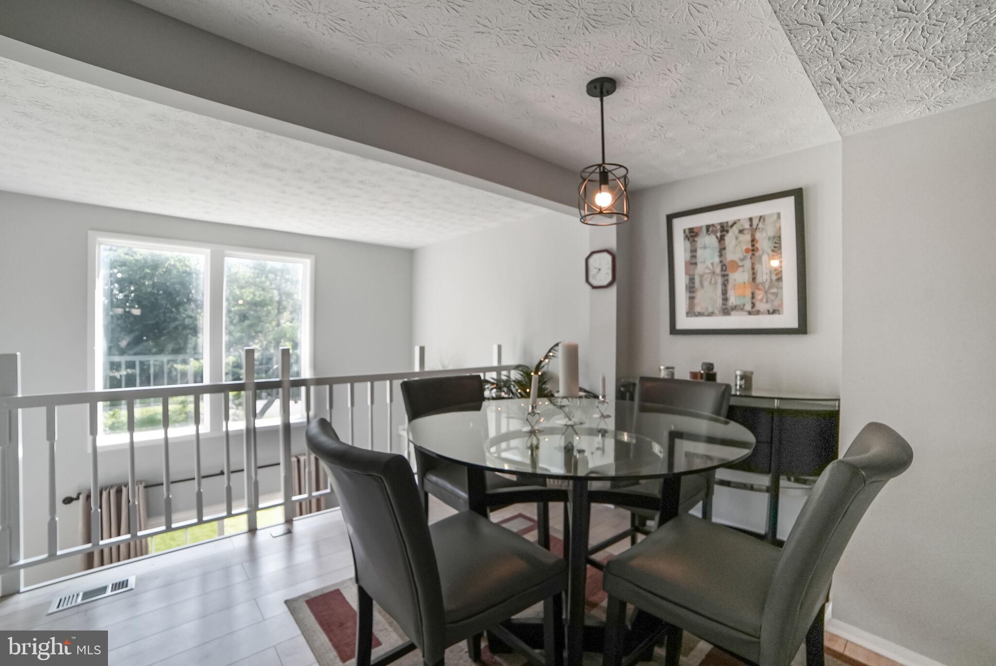 3650 Castle Terrace, Unit 11112 Silver Spring, MD 20904 - Photo 4 of 26 a view of a dining room with furniture window and wooden floor