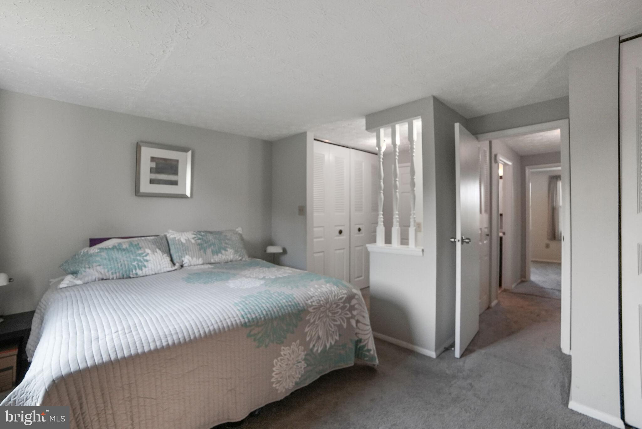 3650 Castle Terrace, Unit 11112 Silver Spring, MD 20904 - Photo 10 of 26 a bedroom with a bed and a chandelier