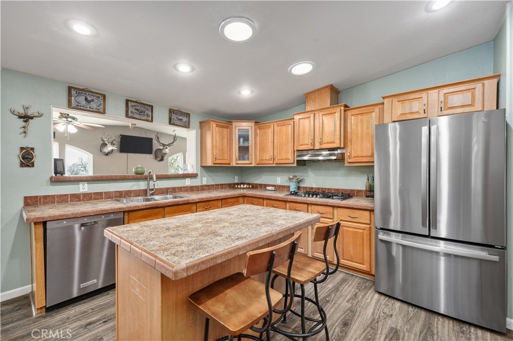 42100 Buckeye Street Caliente, CA 93518 - Photo 32 of 64 a kitchen with stainless steel appliances granite countertop a refrigerator a stove top oven a sink and a refrigerator