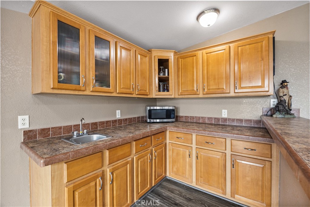 42100 Buckeye Street Caliente, CA 93518 - Photo 39 of 64 a kitchen with stainless steel appliances granite countertop a sink and cabinets
