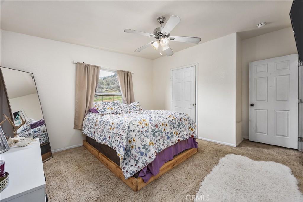 42100 Buckeye Street Caliente, CA 93518 - Photo 47 of 64 a bedroom with a large bed and a chandelier