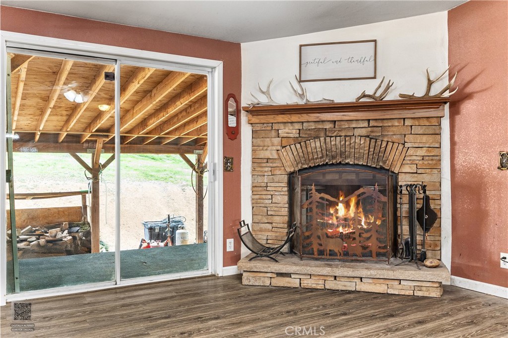 42100 Buckeye Street Caliente, CA 93518 - Photo 6 of 64 a living room with a fireplace and a floor to ceiling window